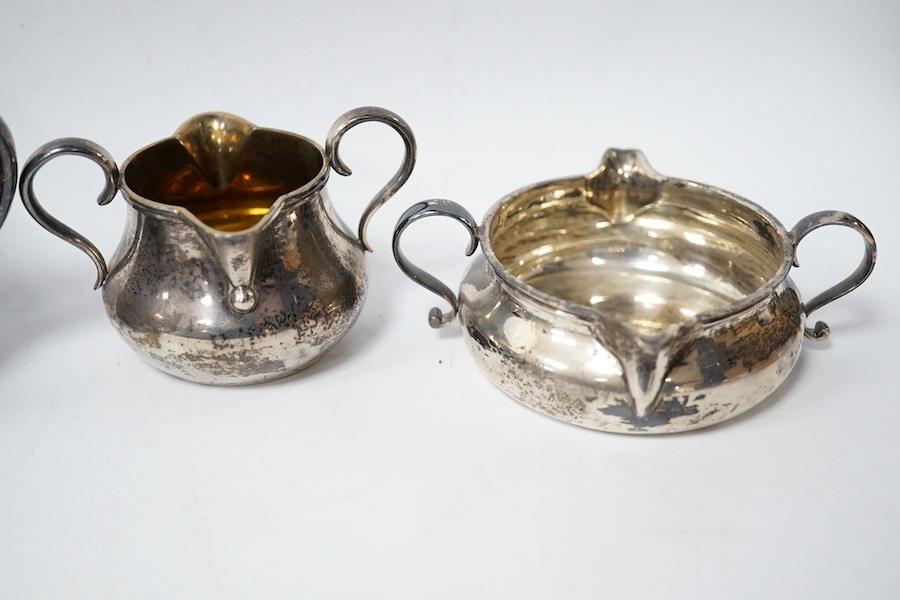 A Victorian silver double lipped cream jug by R & S Garrard & Co, London 1865, height 80mm, together with three other Victorian silver double lipped cream jugs, two by F.B Thomas & Co and one by George Fox, 17.7oz. Condi